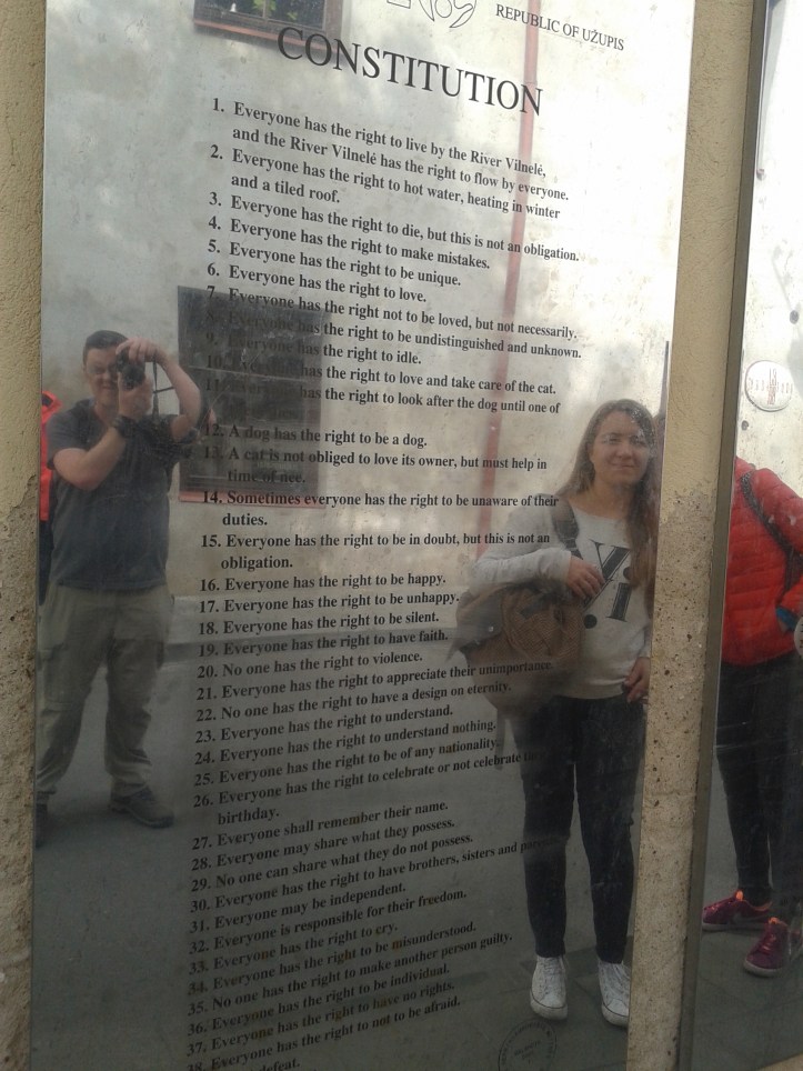 Uma das várias placas com a irreverente Constituição da República de Uzupio, cada uma em um idioma diferente